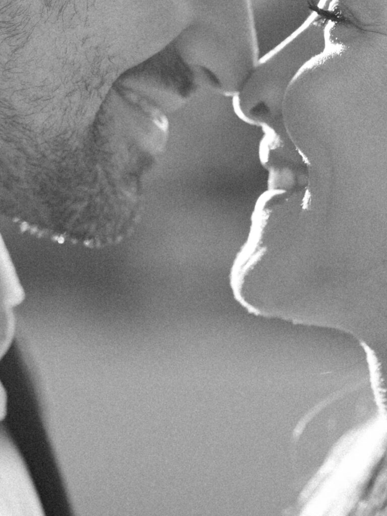 Intimate black and white engagement photo capturing close connection and emotional moment between couple